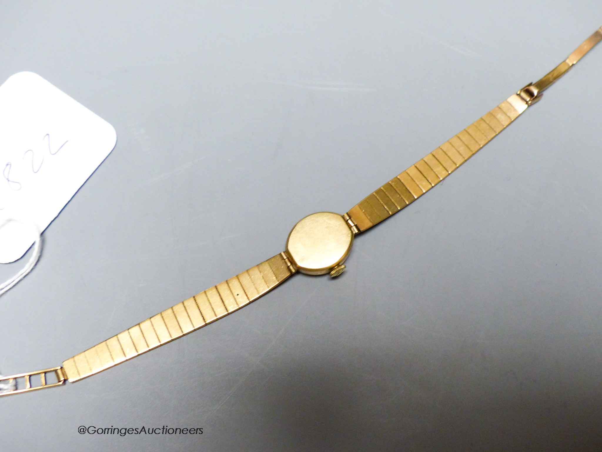 A lady's Audax 9ct gold manual wind wrist watch, on a 9ct gold bracelet